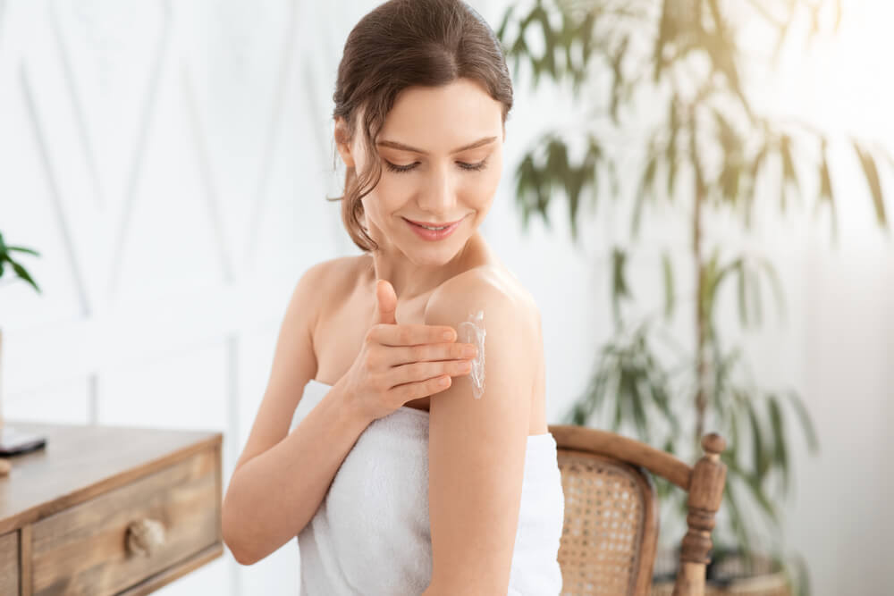 Woman applying Revitalizing Body Butter