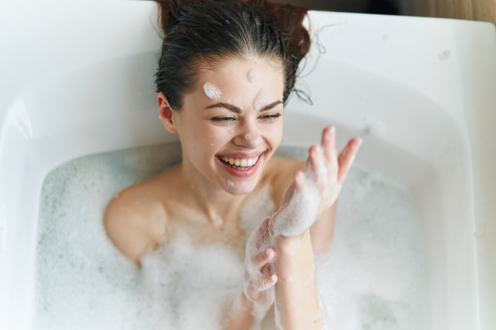 Woman taking bath to de-stress for your skin