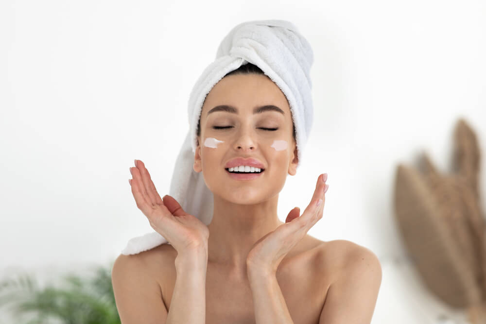 Lady applying day cream