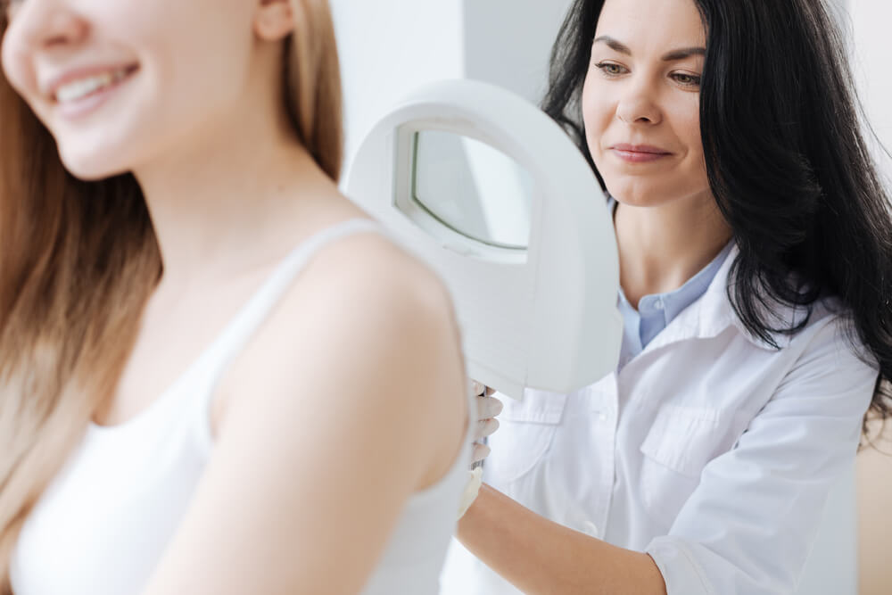 Dermatologist examining woman