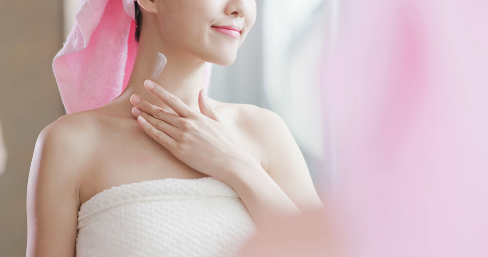 Woman applying neck cream