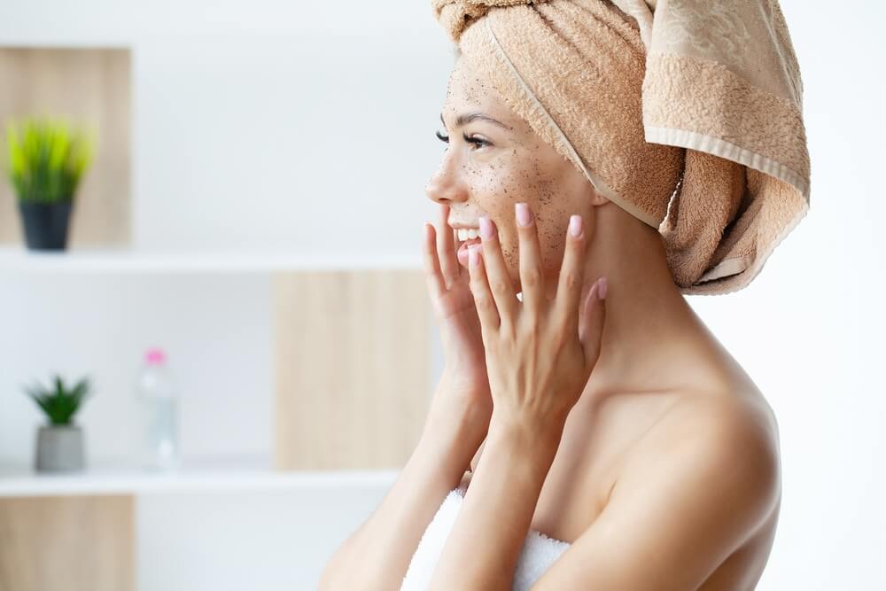 Woman using face scrub