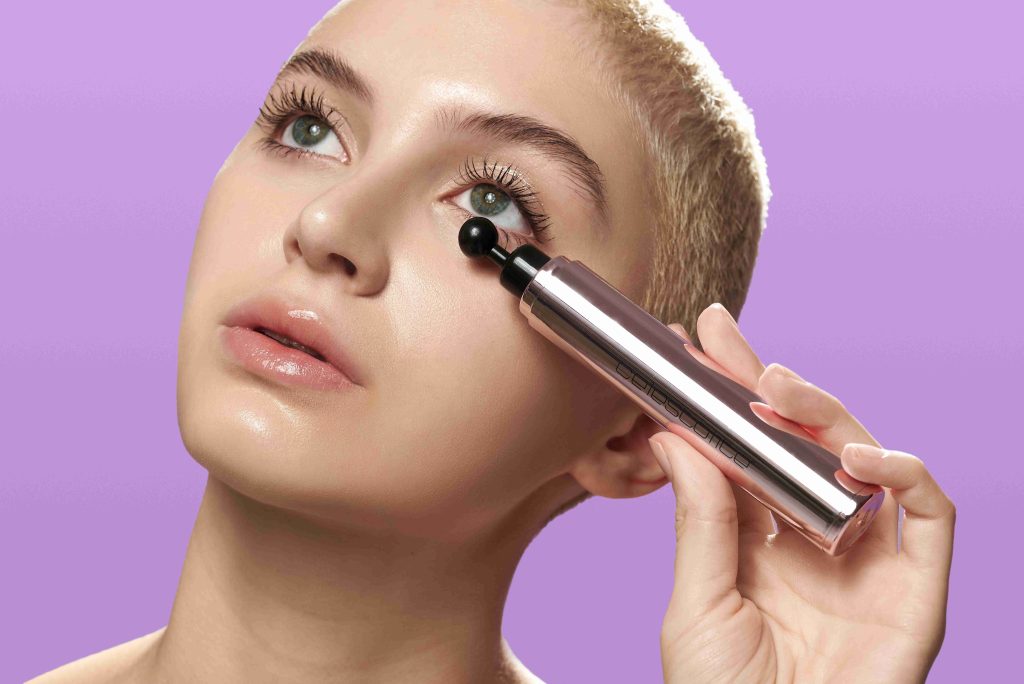 Woman holding the Nova Dark Spot Corrector against her face to tackle the look of dark spots