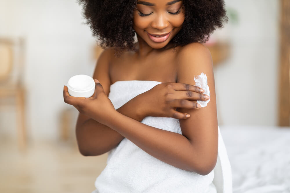 Woman applying body butter