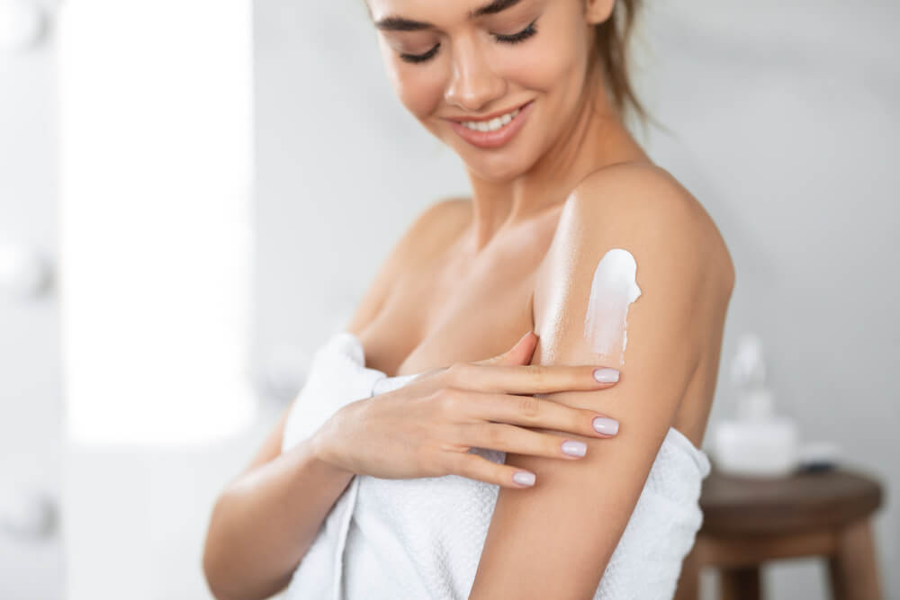 Woman applying body butter