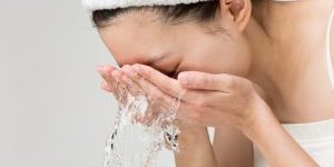woman rinsing face