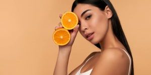 woman holding orange