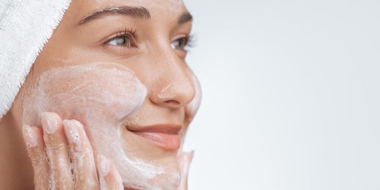 woman double cleansing face